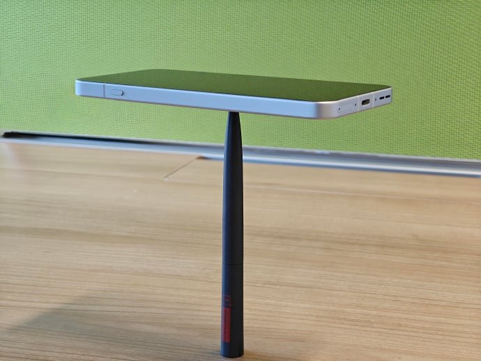 oneplus 13t balanced on a pen 1